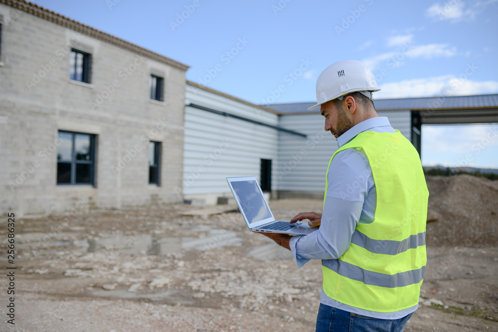 portrait of a handsome young man architect on a building industry construction site portrait of a handsome young man architect on a building industry construction site