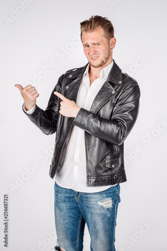 portrait of young man in black eather jacket isolated on a white background. Emotion and people concept.