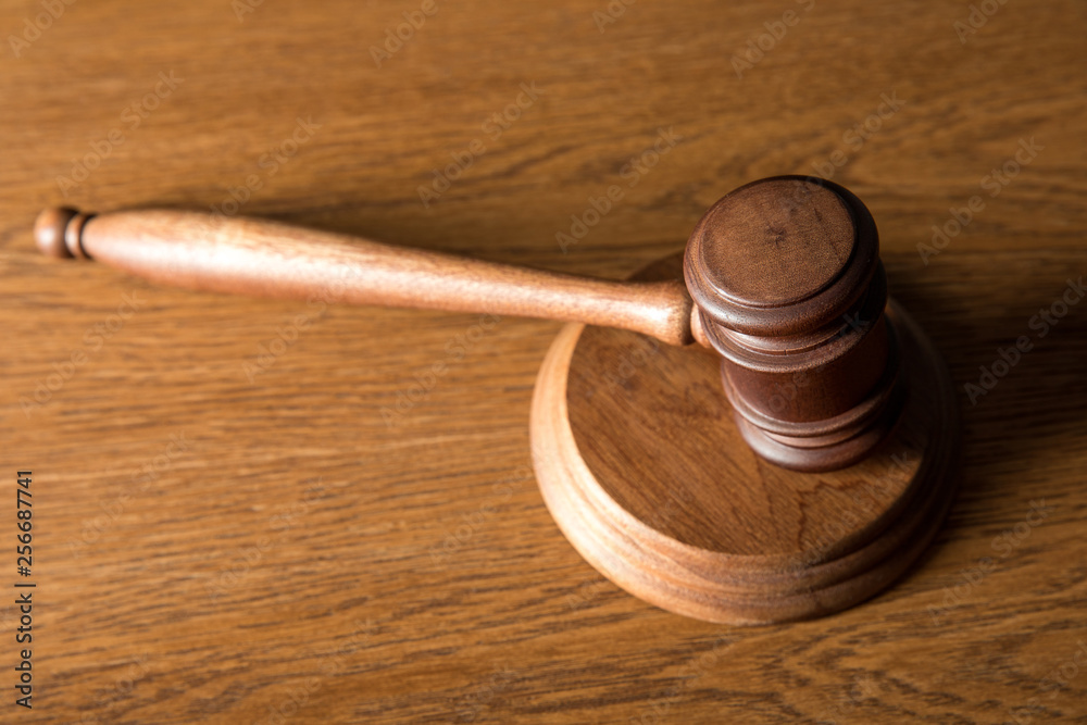 brown wooden gavel on wooden textured table brown wooden gavel on wooden textured table
