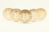 Several Golden Bitcoins on White Background