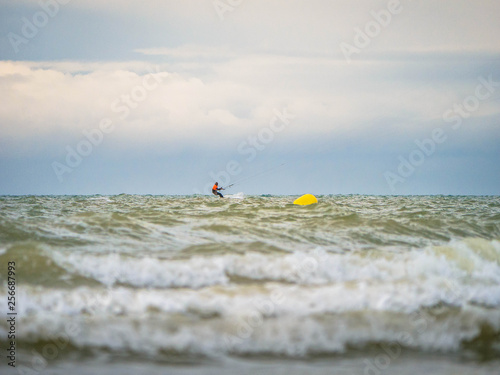 Single Kite Surfer close to a buoy in open seas