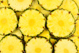 Pineapple juicy yellow slices background. Top view.