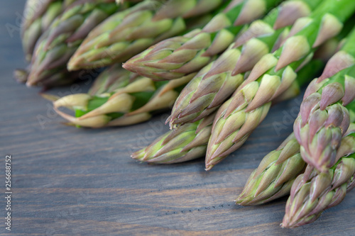 Fresh green asparagus on wooden background