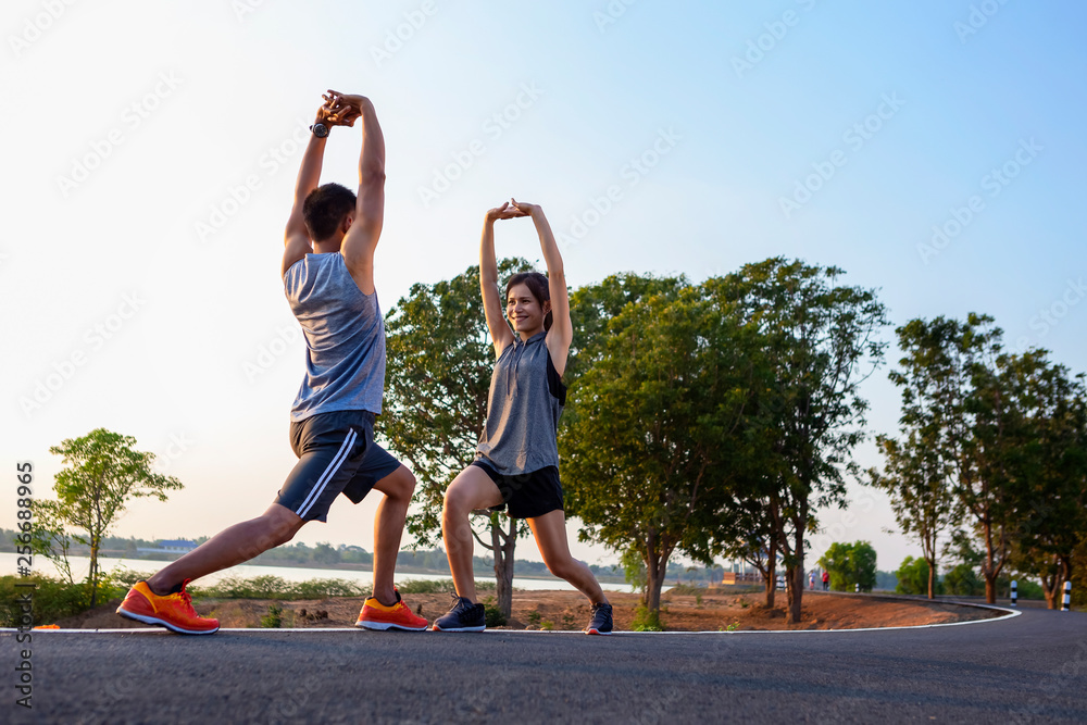 Running at sunrise couple exercising for marathon and workout .fitness, sport, people and lifestyle concept - Happy couples exercising with outdoor running Running at sunrise couple exercising for marathon and workout .fitness, sport, people and lifestyle concept - Happy couples exercising with outdoor running