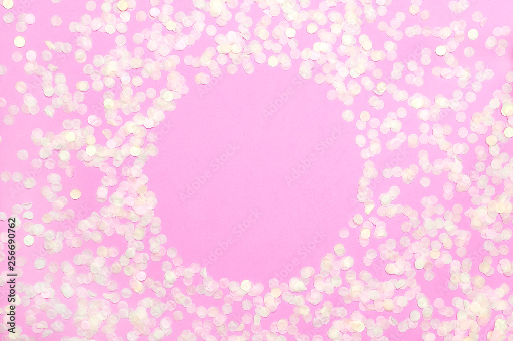Frame of paper round confetti with clear circle in the middle on pastel pink background top view Flat lay. Festive holiday background, concept of party, birthday, christmas or new year Frame of paper round confetti with clear circle in the middle on pastel pink background top view Flat lay. Festive holiday background, concept of party, birthday, christmas or new year
