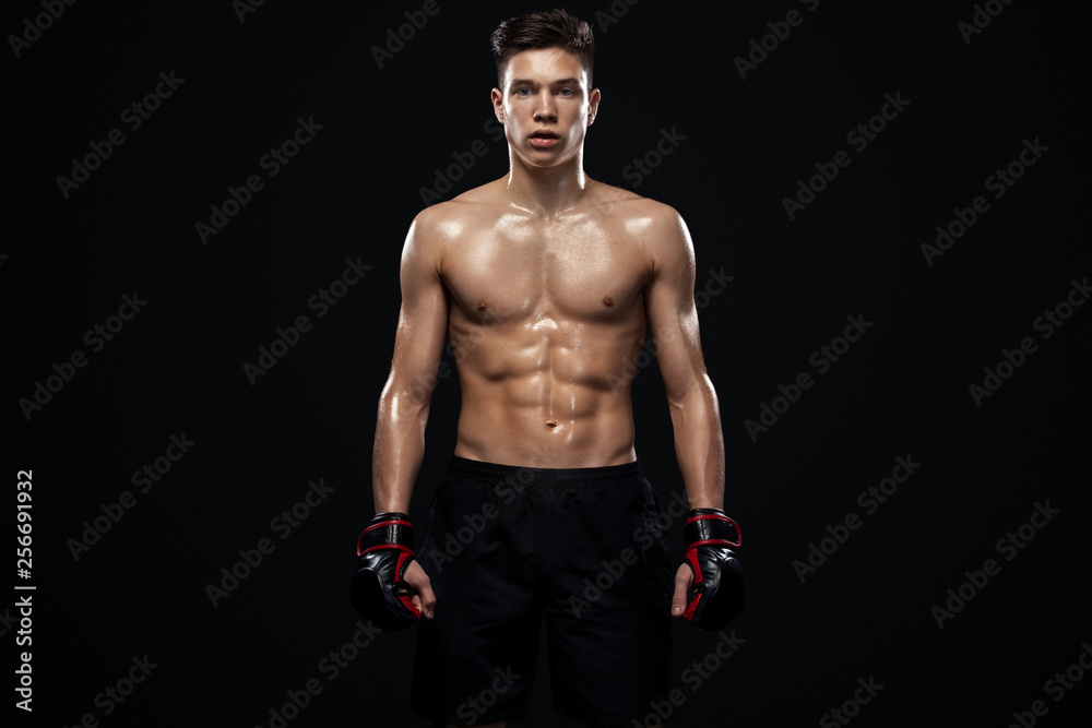 Sportsman teenager boxer fighting on black background with shadow. Copy Space. Boxing sport concept. Sportsman teenager boxer fighting on black background with shadow. Copy Space. Boxing sport concept.