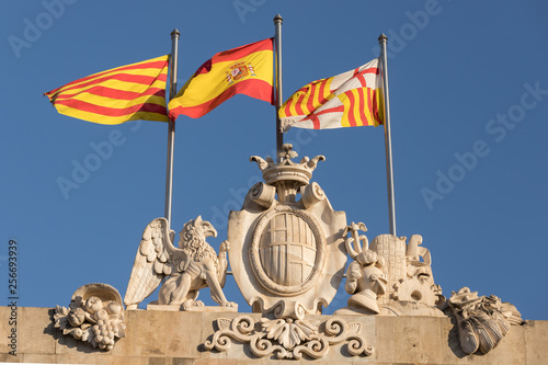 the flags of catalonia, spain and barcelona in the wind photo