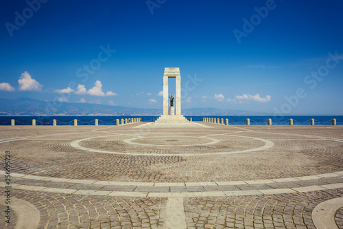 Athena statue on Arena dello Stretto in Reggio Calabria against Messina strait photo