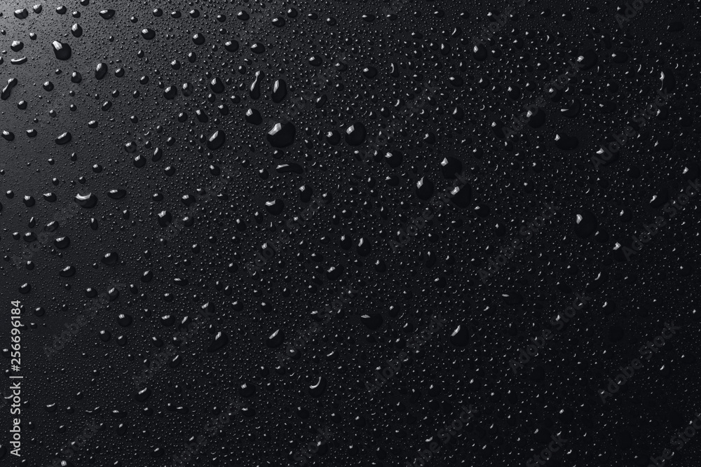 Shiny water drops on black surface, background - obrazy, fototapety, plakaty 