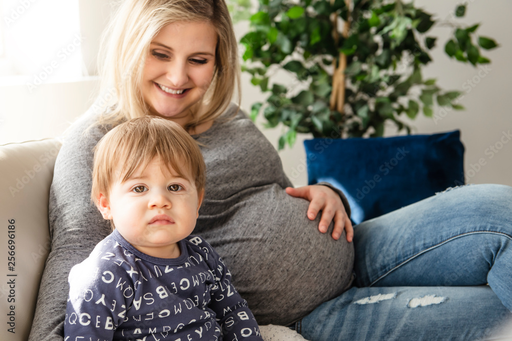 A happy pregnant mother and little son at home A happy pregnant mother and little son at home
