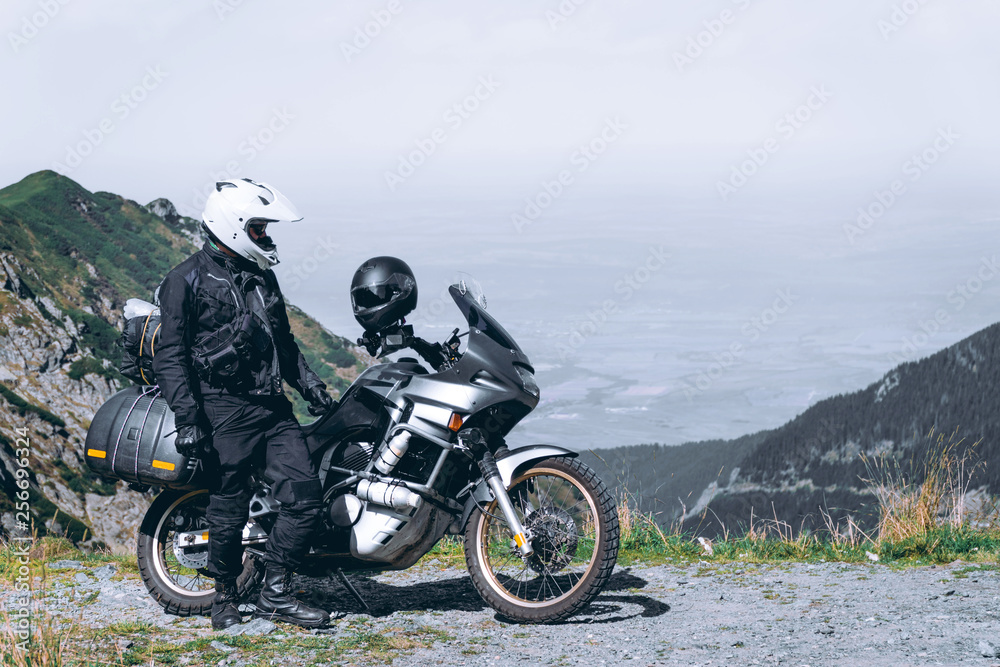 motorcycle adventure on the summit of the mountain, enduro, off road, beautiful view, danger road in mountains, freedom, extreme vacation. Transfagarasan Romania
