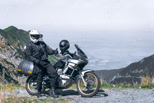 motorcycle rider have fun. adventure on the summit of the mountain, enduro, off road, beautiful view, danger road in mountains, freedom, extreme vacation. Transfagarasan Romania
