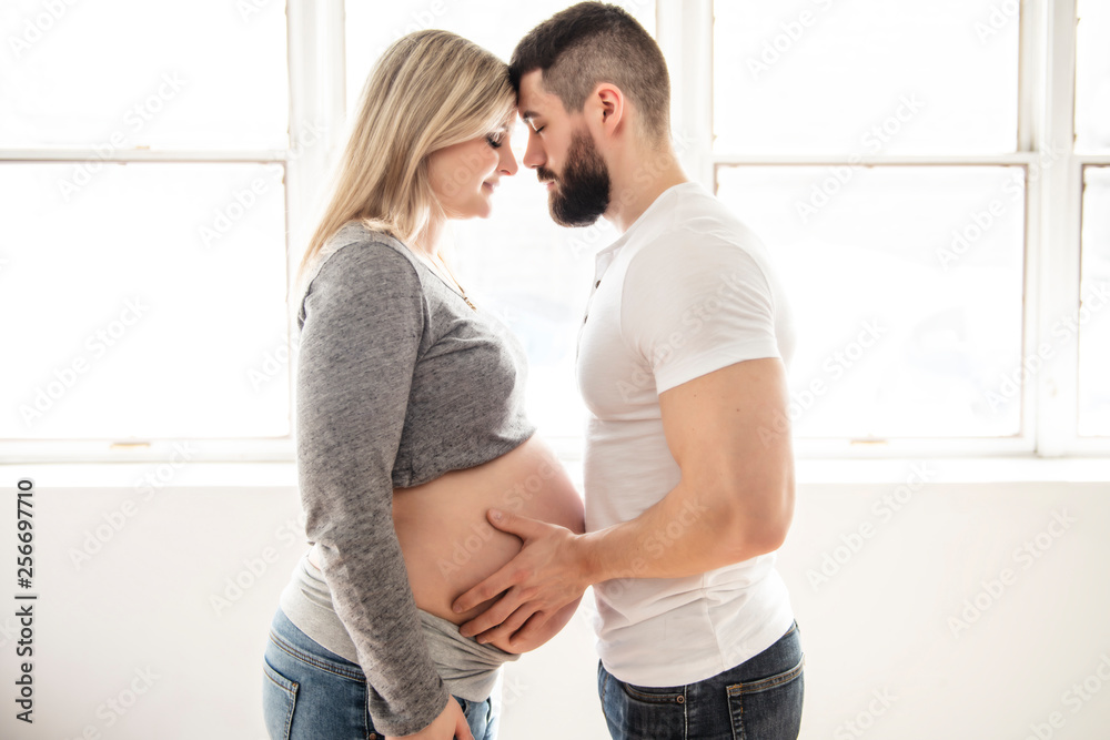 Pregnant women with her husband feeling happy at home Pregnant women with her husband feeling happy at home