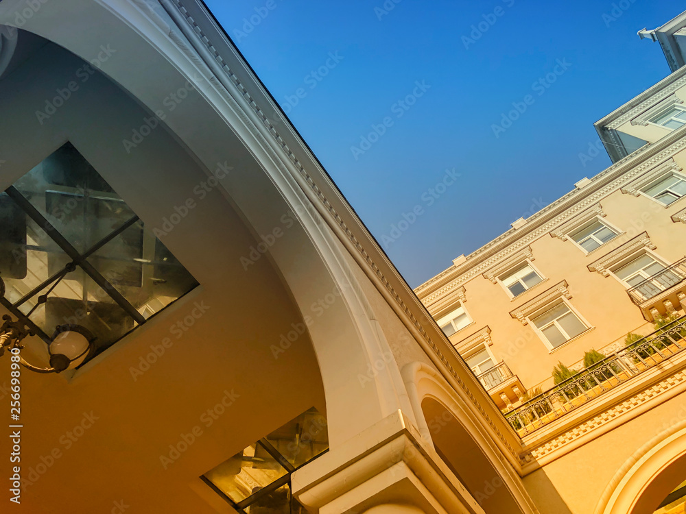 Fototapeta premium Facade of a building with columns against the sky. Bottom to top image