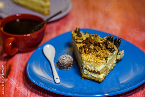 Fototapeta Naklejka Na Ścianę i Meble -  A slice of sponge cake with walnuts close-up.