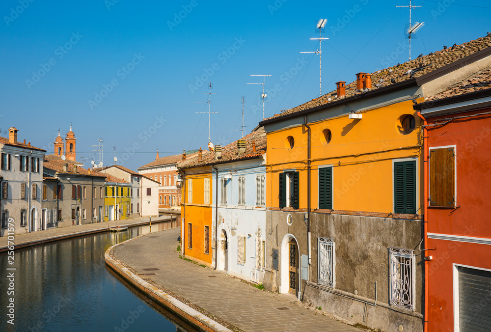 colorful houses along canal in Comacchio, Italy