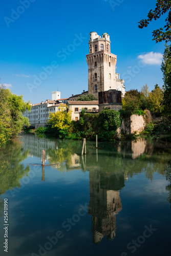 tower of Astronomical Observatory of Padua, Italy, along the river., with reflection