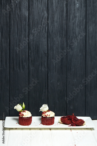 Red velvet cupcakes red velvet with cherry jam on white and black wooden backgrounds © Oleksandr