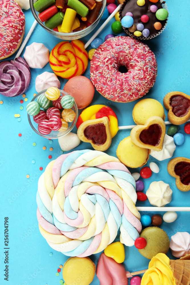candies with jelly and sugar. colorful array of different childs sweets and treats on blue candies with jelly and sugar. colorful array of different childs sweets and treats on blue