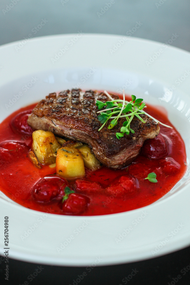 duck breast, vegetables, berry sauce and microgreen (main dish). food background. top view duck breast, vegetables, berry sauce and microgreen (main dish). food background. top view