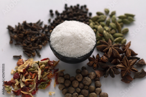 Cup of salt and spices on white background.