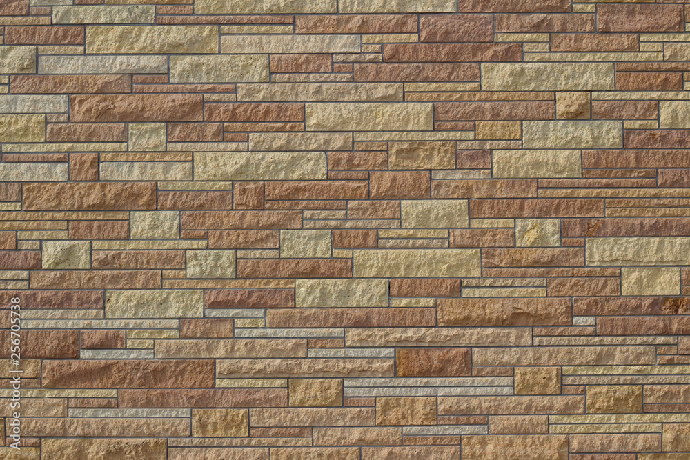 Attractive kasota limestone brick wall background with bricks in varying shades of brown Attractive kasota limestone brick wall background with bricks in varying shades of brown