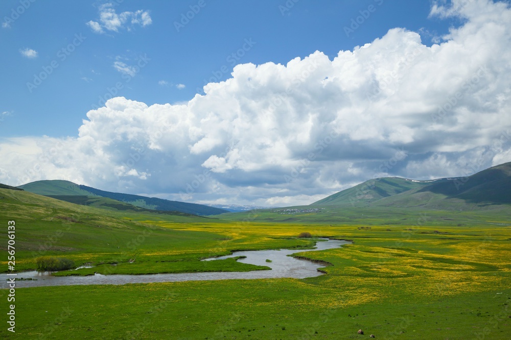Sunny summer landscape with river.Green hills,fields and meadows Sunny summer landscape with river.Green hills,fields and meadows
