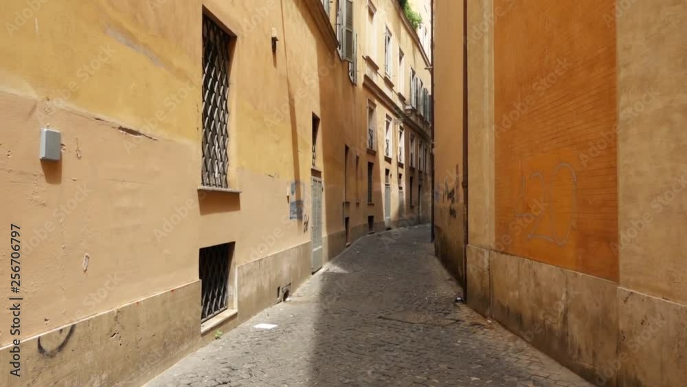 First person view of someone walking along deserted alley in Rome, Italy. POV of tourist going through narrow street First person view of someone walking along deserted alley in Rome, Italy. POV of tourist going through narrow street