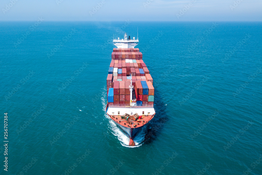 Large container ship at sea - Low angle aerial image.