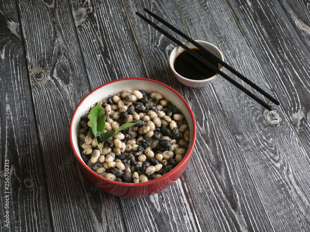 Stewed beans with soy sauce on a wooden table. Stewed beans with soy sauce on a wooden table.