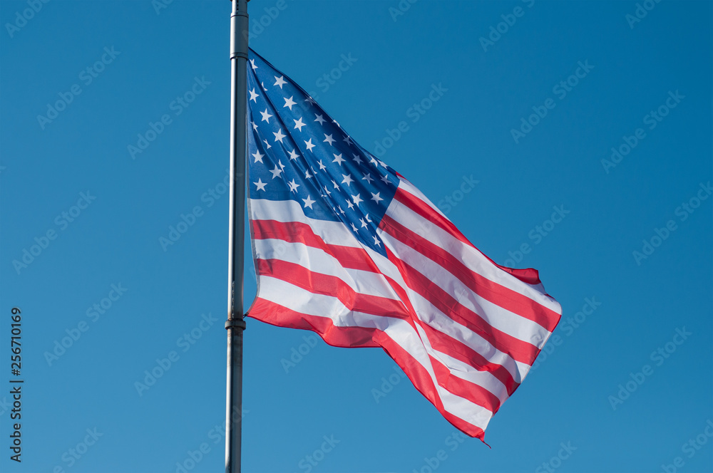 closeup of american flag on blue sky background