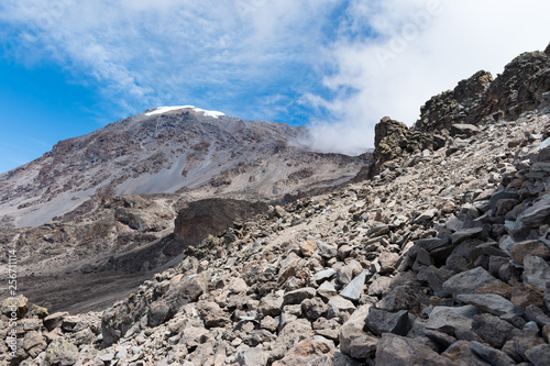 View of the southern face of Mount Kilimanjaro taken from the alpine desert zone on the Machame hiking route close to the Barafu base camp. The rocky ridge extends up to Stella Point and Uhuru Peak.