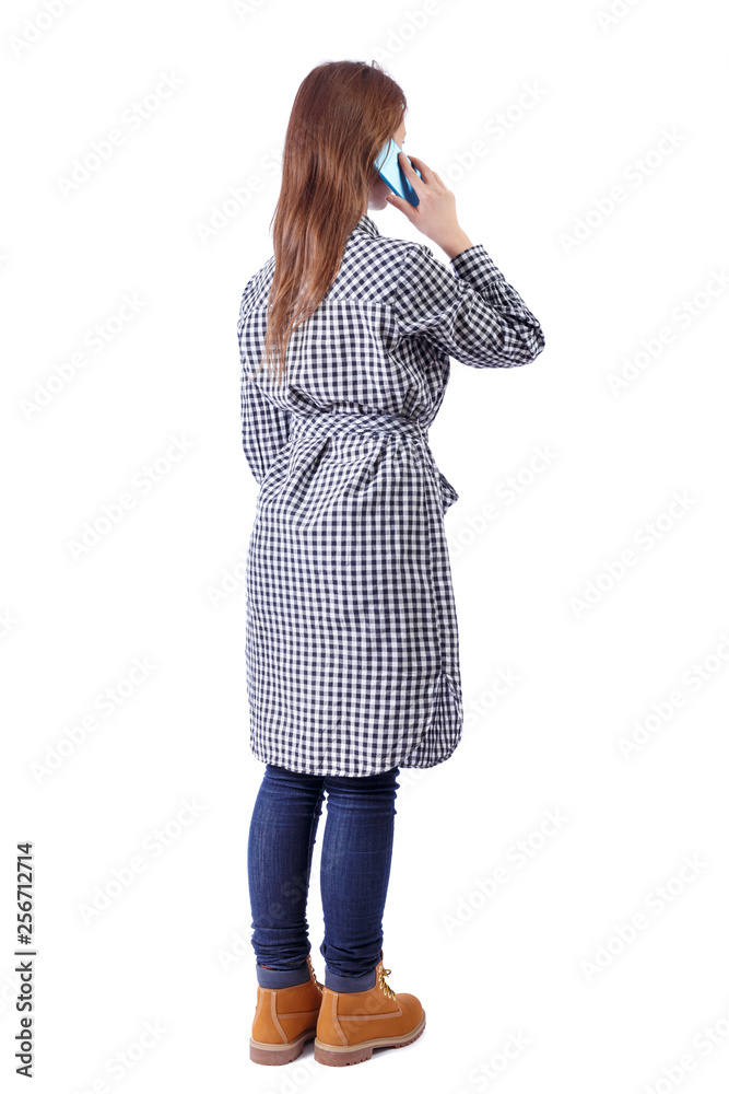 Fototapeta premium back view of a woman talking on the phone.