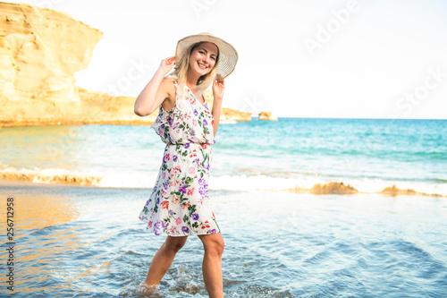 The summer holidays and vacation concept girl in dress standing on the beach