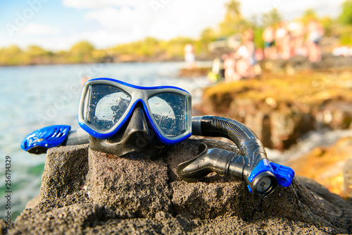 Canvas Print A Colorful snorkle or diving mask located on the rocks with snorkling group on t