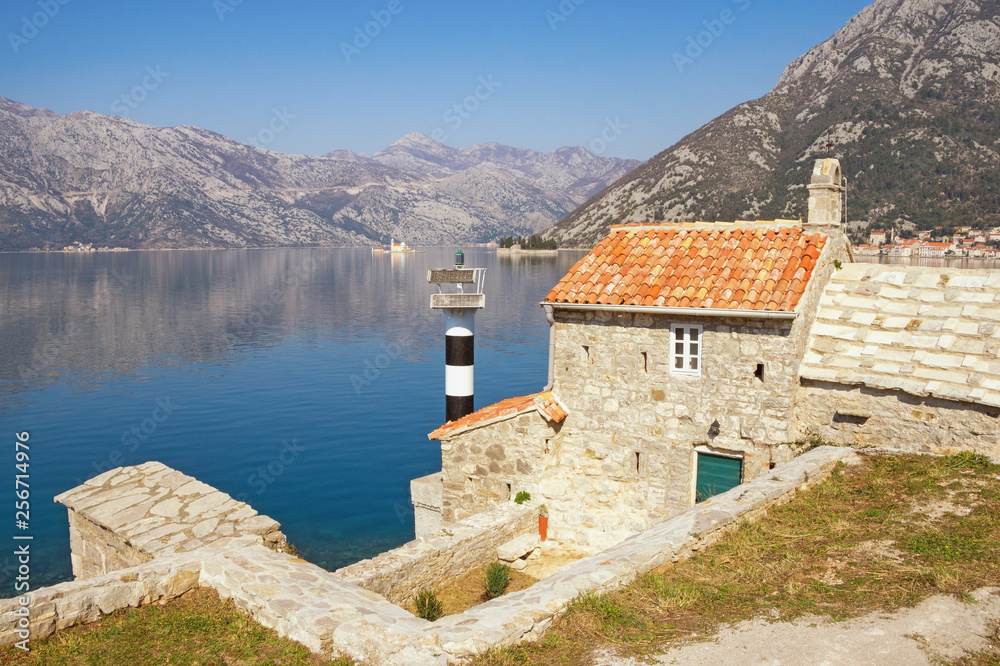 Beautiful Mediterranean landscape on sunny spring day. Montenegro, Adriatic Sea. View of Bay of Kotor, ancient Church of Our Lady of  Angels and two small islands 
