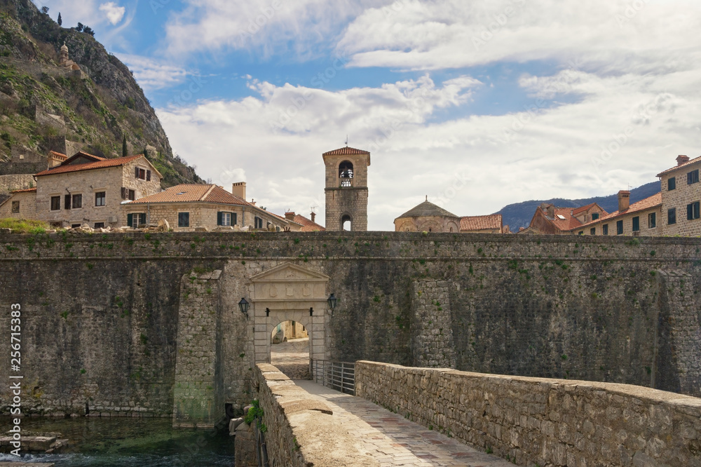 Montenegro . Old Town of Kotor, UNESCO-World Heritage Site. View of northern walls of ancient fortress, River Gate (or North Gate) and Belfry of St. Mary's Church