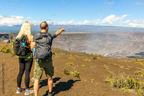 The Hiking couple seeing volcano national park from crater on the caldera Halemaumau around Hawaii volcanoes national park photo