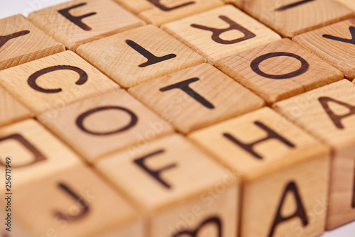 wooden cubes on a white background and various chaotic letters photo