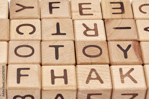 wooden cubes on a white background and various chaotic letters photo