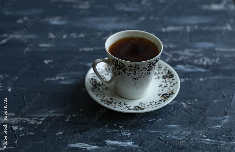 Fototapeta premium White cup with black coffee on a dark background