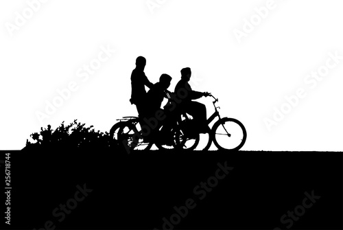 Three boys on bikes silhouette