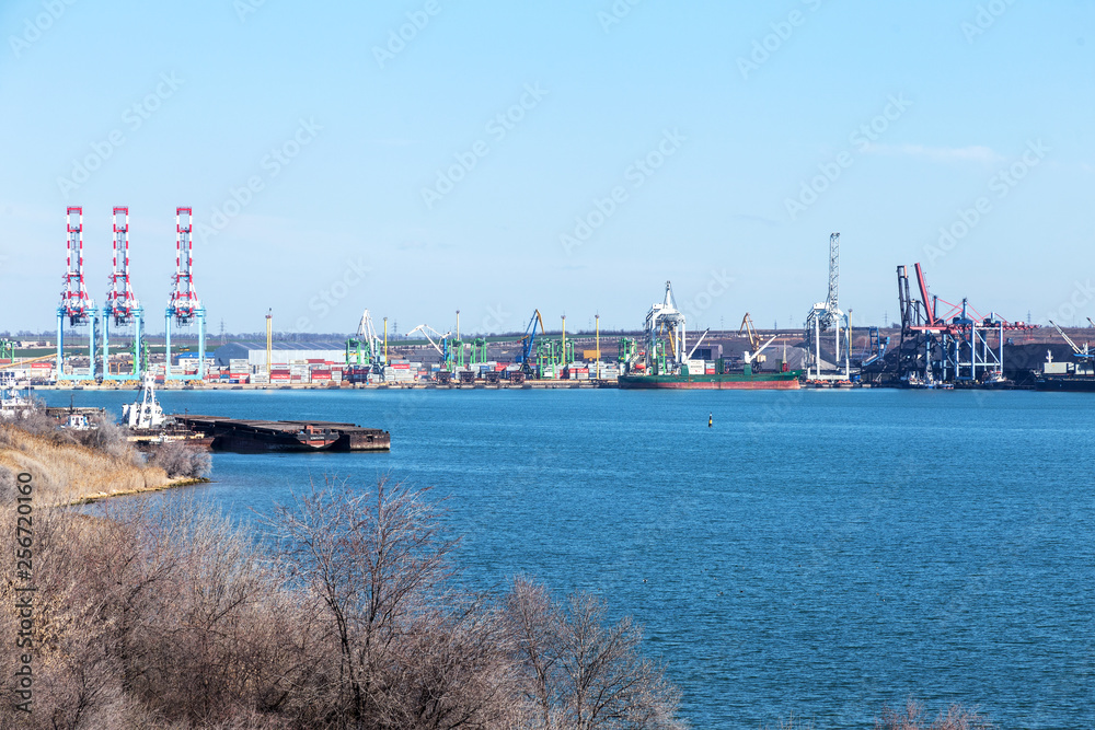 Odessa, Ukraine, South-March 20, 2019: Aerial view of panoramic seaport warehouse and container ship, crane vessel is working to deliver containers. South Sea Industrial Port, Port Factory
