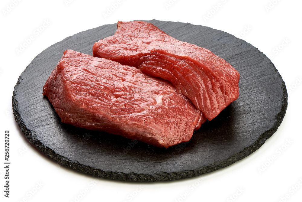 Fresh raw beef steaks on slate shale plate, sliced meat, close-up, isolated on white background