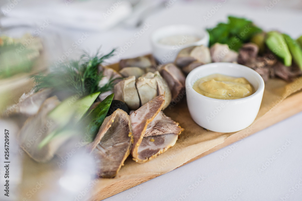 Cold cuts on a wooden chopping Board. Banquet at the restaurant