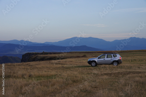All wheel drive car on meadow on edge of Debed river canyon, Armenia. Sunset time.