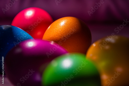 Colorful Easter eggs in basket on soft  plain background 