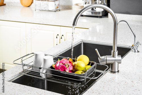 Rinse fruits and vegetables in the kitchen sink with water