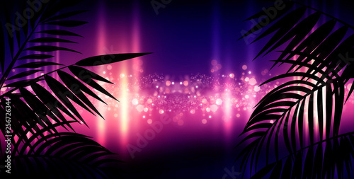 Dark background with colorful bokeh of tropical leaves. Night view, gradient and abstract bokeh light. Magic twinkling sparkles.
