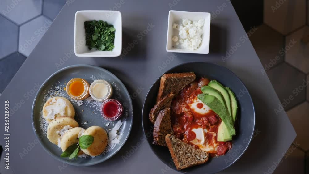 Top view diverse dishes with breakfast on a plate in cafe bar